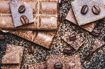Chocolate bar pieces. Background with chocolate. Sweet food photo concept. The chunks of broken chocolate