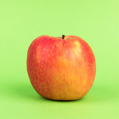 red apple on green background
