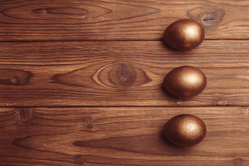 gold eggs on wooden table