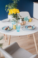 Pastel table decoration on navy blue wall