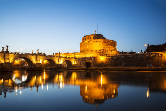 View of the Castle of St. Angelo or the Mausoleum of Hadrian and St. Angel's bridge at night, Italy