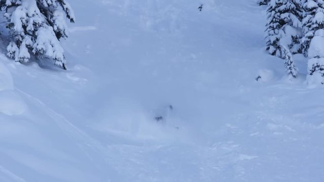 Skier tumbles down hillside, slow motion