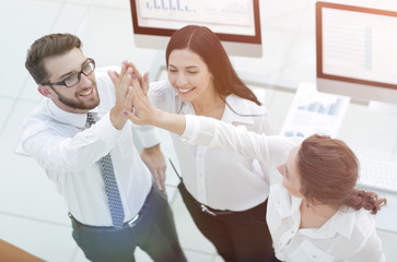 Fototapeta premium successful business team giving each other a high five .