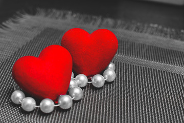 two hearts and beads on a textured substrate