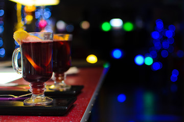 two glasses of mulled wine on a bokeh background