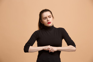 Let me think. Doubtful pensive woman with thoughtful expression making choice against pastel background