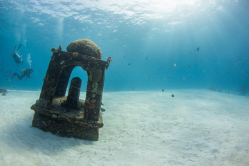 Underwater seascape with natural sunlight through water surface and rocks on the seabed.underwater background
