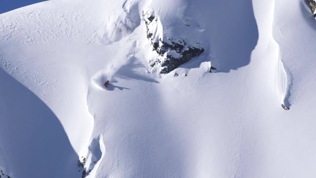 Aerial from helicopter, skier on British Columbia slope