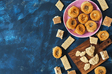 Eastern sweets, baklava, halva, sherbet. Top view, space for text.