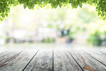 Empty wooden table with party in garden background blurred.