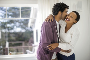 Happy couple hugging in new home
