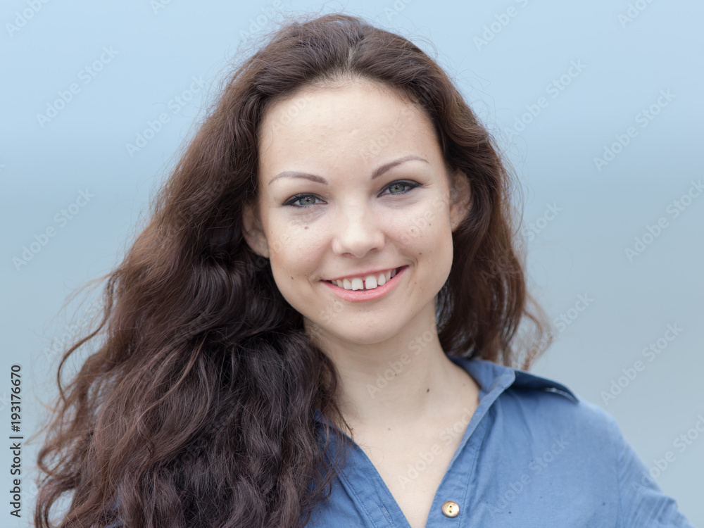 Wall mural Portrait of girl with curly hair and gap between teeth