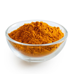 Turmeric powder in glass bowl isolated on white.