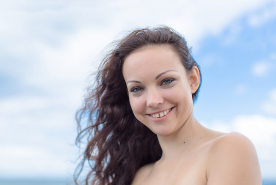 Smiling Girl With Curly Hair And Gap Between Teeth