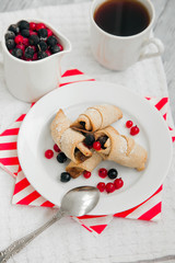 sweet bagels cookies and berries on a plate with two white cups