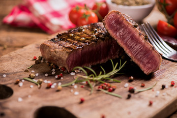Delicious beef steak on wooden table, close-up