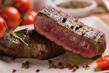 Delicious beef steak on wooden table, close-up
