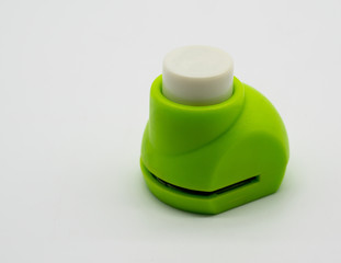 Mini green paper puncher for DIY scrapbook and craft isolated on white