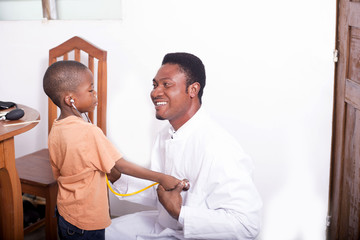 Obraz premium at the pediatrician. Kid plays doctor with Pediatrician