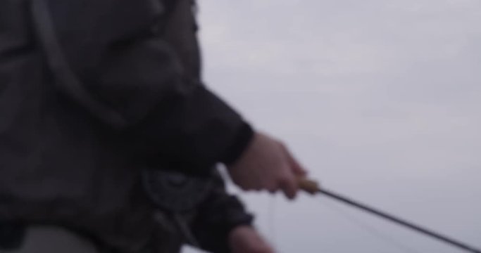 Fisherman adjusts slack line