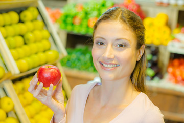 Woman holding a red apple