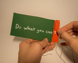 Repairing motivational note by sewing