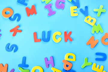 Obraz premium Beautifully laid out inscription luck of multi-colored letters. Background.