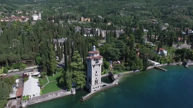 castle. Panorama of the gorgeous Lake Garda surrounded by mountains, Italy. video shooting with drone