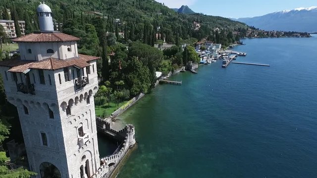 castle. Panorama of the gorgeous Lake Garda surrounded by mountains, Italy. video shooting with drone
