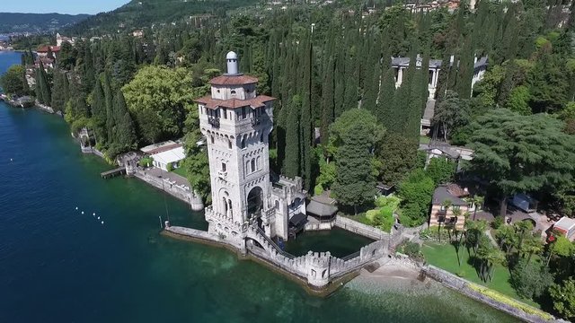 castle. Panorama of the gorgeous Lake Garda surrounded by mountains, Italy. video shooting with drone