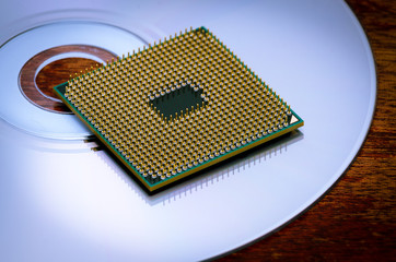 A square computer processor pulled from a broken computer. The processor lies on a compact disc. View on the contacts. dalszy plandoswiadczeniedoświadczeniedrugi plankonteksttapetatlotłocentralnyzamkn