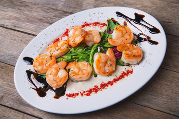 baked shrimp with sauce and herbs