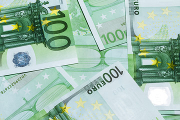 Banknotes of a hundred euros scattered and draped on the table