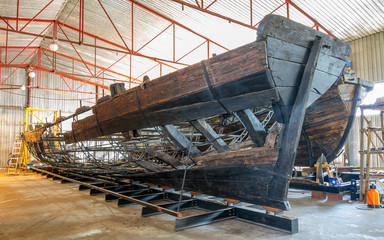 Naklejka premium Old vintage wooden boat on restoration