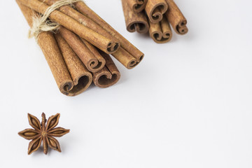 Spices: star anise and cinnamon sticks on white background. Close up. Top view.