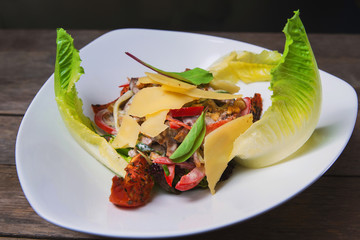 Salad of meat, vegetables, cheese and sauce