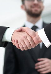 closeup handshake proven business partners