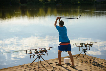Fisherman attract fish with bait in river or lake