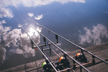 Tackles on pod on wooden pier, fishing