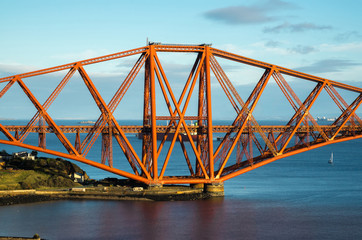A view from the east footpath of the Forth Road Bridge, looking over North Queensferry harbour towords one of the towers of the old and famous Rail Bridge.