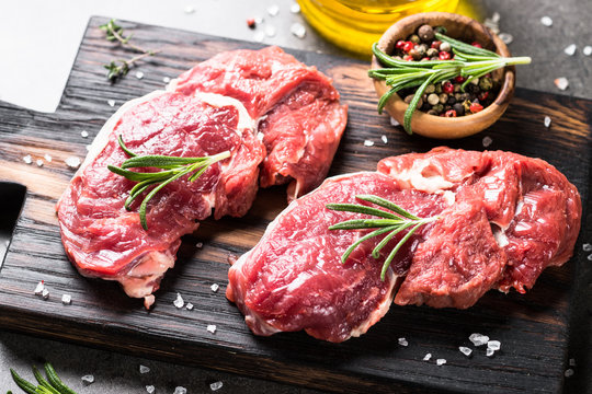 Raw beef steak with herbs.