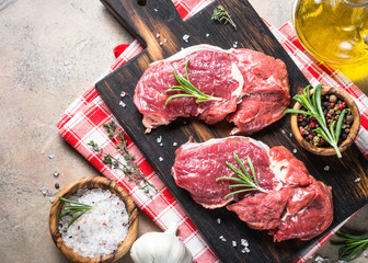 Fototapeta na wymiar Raw beef steak with herbs top view.