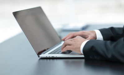 closeup.businessman working on laptop