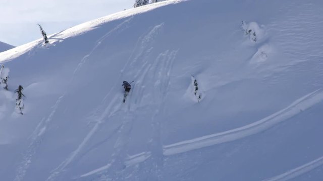 Skier wipes out after going off ski jump, slow motion