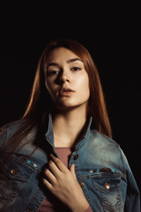 Wonderful young woman with natural makeup and perfect skin wearing trendy jeans jacket