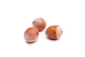 Three hazelnuts isolated on white, food background