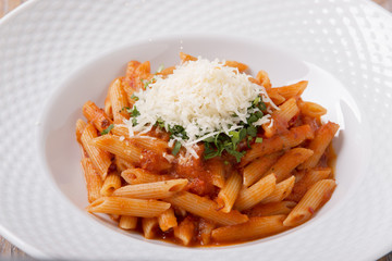 pasta penne with parmesan cheese tomato sauce greens