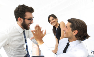 business colleagues giving each other high five.