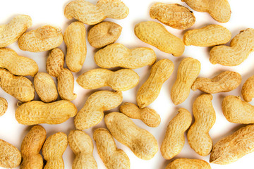 Heap of peanuts as background. Macro view of shelled peanuts.