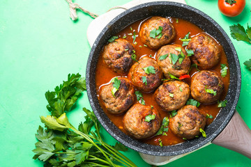 Meatballs in tomato sauce in a frying pan top view. 
